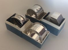 Four silver napkin rings of various dates and make