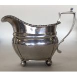 A small silver Georgian style cream jug. London. A