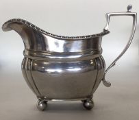 A small silver Georgian style cream jug. London. A