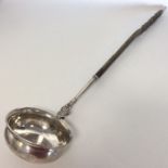 A large Georgian silver toddy ladle with twisted w