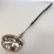 A large Georgian silver toddy ladle with twisted w