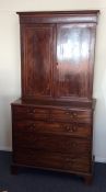 A Georgian mahogany bookcase, the base with five d