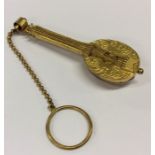 A gilt metal vinaigrette in the form of a banjo wi