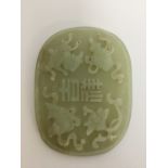 A large Chinese oval carved jade panel. Approx. 85