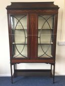 An Edwardian inlaid display cabinet decorated with