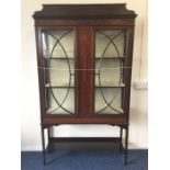 An Edwardian inlaid display cabinet decorated with