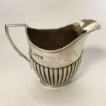 A small bachelor's silver half fluted cream jug wi