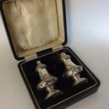 A boxed pair of solid based silver peppers. Birmin