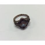 An Antique gem set cluster ring in heavily embosse