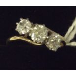 A large diamond three stone crossover ring in plat