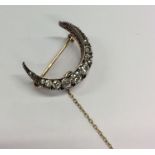 An attractive Antique diamond crescent brooch with