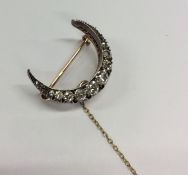 An attractive Antique diamond crescent brooch with