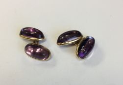 A pair of cabochon amethyst earrings with gold loo