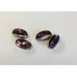 A pair of cabochon amethyst earrings with gold loo