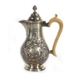 A Victorian silver and repousse decorated bachelor's hot water jug of baluster form, maker P&Co.