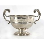 An early 20th century silver two handled trophy vase of squat form having leaf capped c-scroll
