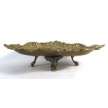 A 19th century brass table centre decorated with a leaping cherub amidst foliate borders,