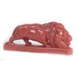 An Art Deco-type figure modelled as a crouching lion, w.