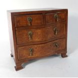 Miniature Furniture: a thuya and feather crossbanded bow fronted chest of two short over two long