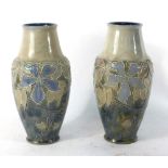A pair of Royal Doulton tube-line vases decorated with flowering shrubs, h.