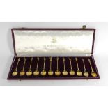 A cased set of twelve silver gilt collector's spoons each end modelled as a historical figure