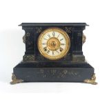 An American mantle clock, the movement and enamelled face within a marble and brass mounted case,