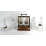 A Victorian oak two-bottle tantalus with silver plated mounts,