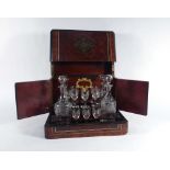 A Napoleon III figured walnut, crossbanded, strung and brass mounted 'cave a liqueur' or tantalus,