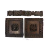 A pair of Victorian oak panels mounted with lion heads, 31 x 28 cm each,