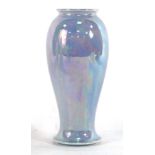 A 1922 Ruskin Pottery vase of slender form decorated in a teal lustre glaze, h.