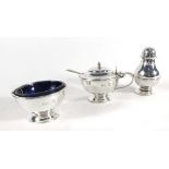 A five piece Britannia silver condiments set comprising a pair of bulbous shaped peppers,