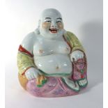 A Chinese figure modelled as the seated Buddha, h. 28.