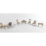 Miniature Furniture: A pair of silver Chippendale-style dining chairs, a settee and a coffee table,