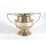 A late Victorian silver two handled trophy vase having a pair of reeded handles above a gadrooned