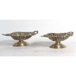 A pair of late 19th/early 20th century silver two handled bon bon dishes of oval form repousse