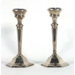 A pair of silver dwarf candlesticks of canted form, maker S&M, Birmingham 1974, h.