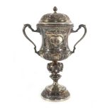 An early 20th century miniature silver two handled covered trophy vase of typical form repousse
