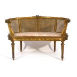 A Louis XV-type giltwood and bergere seat of kidney for on turned legs, l.
