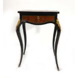 A 19th century French ebonised, walnut, and gilt metal mounted sewing table on cabriole legs, w.