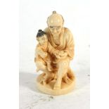 A 19th century carved ivory netsuke modelled as a father and son, h.