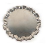 An early 20th century miniature silver salver/card tray of circular form with piecrust border,