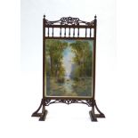 An Edwardian mahogany firescreen, the oil panel within a Gothic-type frame, h.
