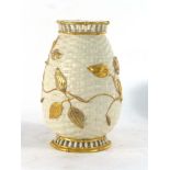 A Royal Worcester vase, the cream ground of trellis form decorated with gilt spreading leaves, p.d.