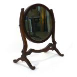 A 19th century mahogany toilet mirror, the oval plate on a swing frame, h.
