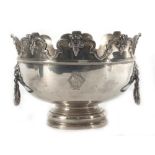 An early 20th century silver rose/punch bowl of typical form with scrolled castellated border above