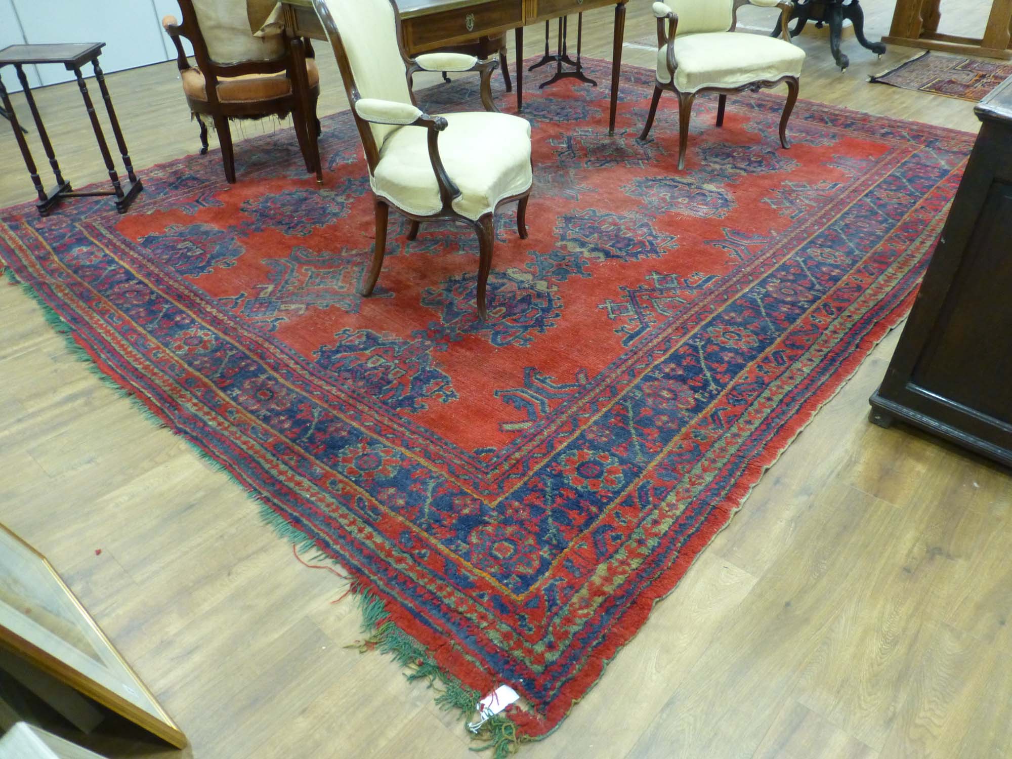 An early 20th century red ground rug with repeated motifs within red and blue bands, - Image 3 of 8
