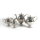 A late 19th/early 20th century Dutch metalware four piece tea and coffee service of ovoid form with