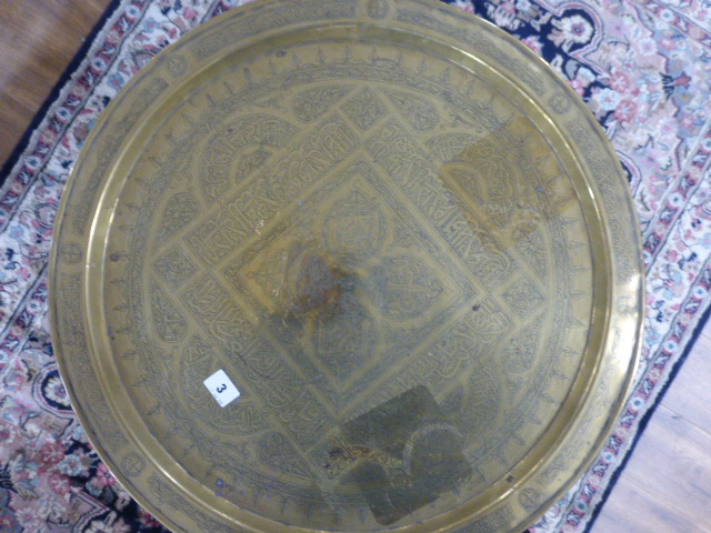 An Eastern tray table, the brass tray resting on a hardwood and mother-of-pearl inlaid folding base, - Image 2 of 2