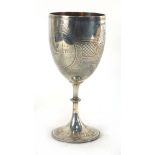 A Victorian silver goblet of typical form having foliate engraving within a beaded border,