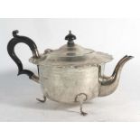 An Edwardian silver teapot of squat form on three pad feet, maker AM, Birmingham 1910, h. 13.